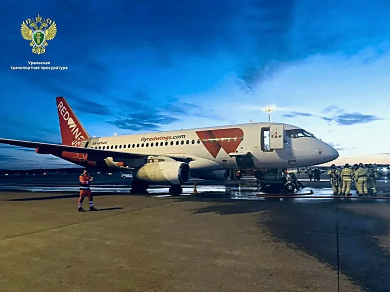 Борт RA-89044 авиакомпании Red Wings на перроне Кольцово в сумерках после инцидента 20 сентября, у носовой части сотрудники аэродромных служб